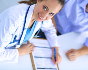 Doctor woman sitting with  male patient at the desk