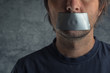 © Bits and Splits - Censorship concept, man with duct tape on mouth