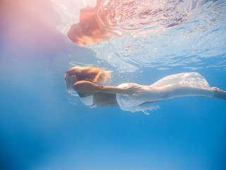 Wall Mural - beautiful woman in white dress underwater