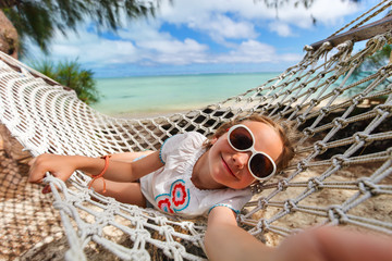 adorable little girl relaxing in hammock