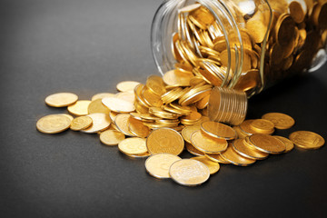 Sticker - Glass jar with coins on dark background