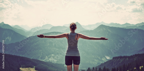 Fotomural Woman celebrating nature and reaching the summit