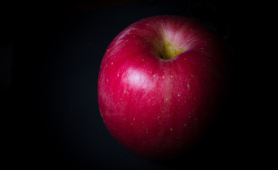 red apple on black background