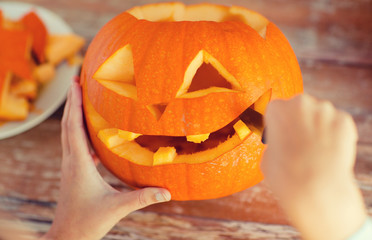 Wall Mural - close up of woman with pumpkins at home