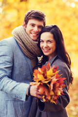 Wall Mural - smiling couple hugging in autumn park