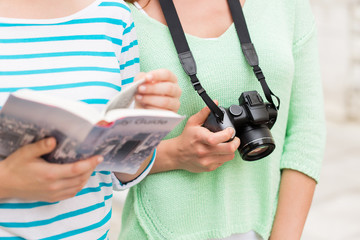 Canvas Print - close up of women with city guide and camera