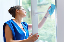 Attractive Woman Washing The Window. Cleaning Company Worker Wor