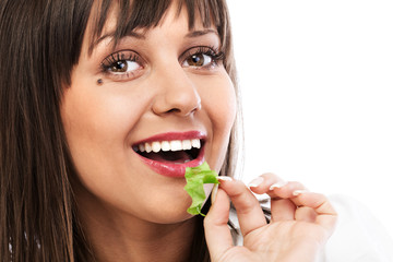 Canvas Print - Young woman eating green salad