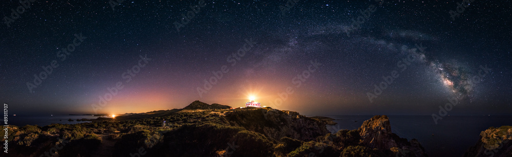 360° rectilinear panoramic view of starry night with milky way arc and lighthouse of Capo Spartivento  - obrazy, fototapety, plakaty 
