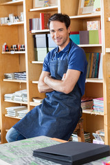 Wall Mural - Worker With Arms Crossed Sitting In Book Store