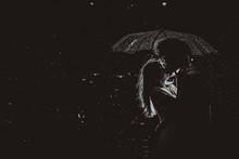 Dramatic Photo Of A Bride And Groom In The Night Rain.