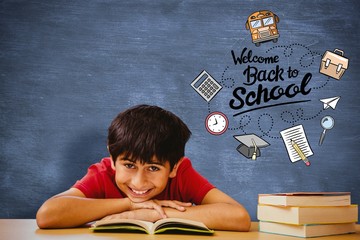 Canvas Print - Composite image of portrait of boy reading book in library