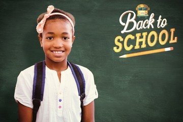 Canvas Print - Composite image of little girl smiling in school corridor