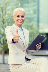 Sticker - smiling businesswoman with tablet pc outdoors