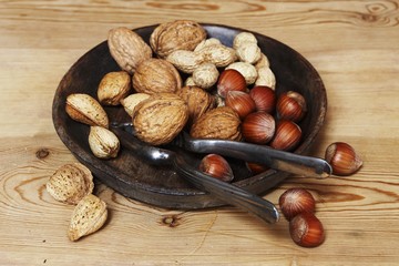 Wall Mural - Assorted nuts in dish with nutcracker