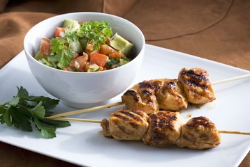 Wall Mural - Grilled chicken kebabs with an avocado and tomato salad