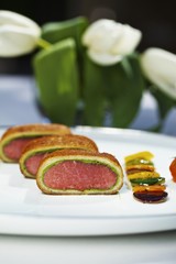Wall Mural - Saddle of lamb with a bread and ramson crust and a side of vegetables
