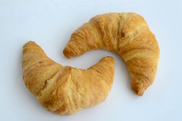Wall Mural - Two croissants against a white background