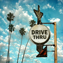 Aged And Worn Vintage Photo Of Drive Thru Sign With Palm Trees