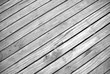 angled ground view of textured timber boardwalk in black and white