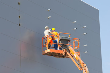 Workers in lifting cage