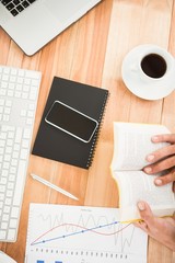 Poster - Businessman reading book on wooden desk