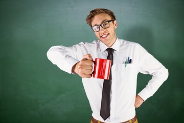 Poster - Composite image of young geeky businessman holding mug