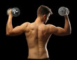 © Africa Studio - Muscle young man holding dumbbells on dark background