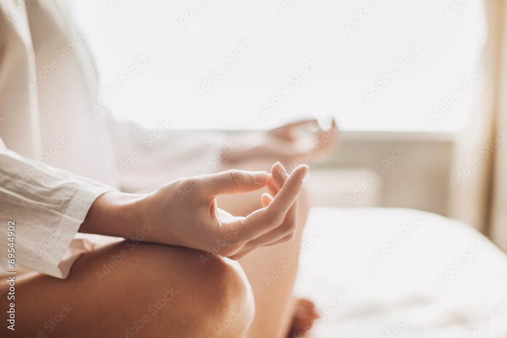 Yoga woman meditating and practicing yoga at home. Recreation, self care, yoga training, fitness, breathing exercises, meditation, relaxation, healthy lifestyle concept - obrazy, fototapety, plakaty 