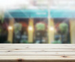© nuttapol - Table Top And Blur Building Background