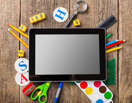 Composite image of digital tablet on students desk showing back