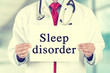 doctor hands holding white card sign with sleep disorder text message