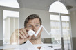 © Westend61 - Businessman drawing diagram on glass pane in office