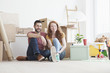 © Westend61 - Young couple in new flat with cardboard boxes