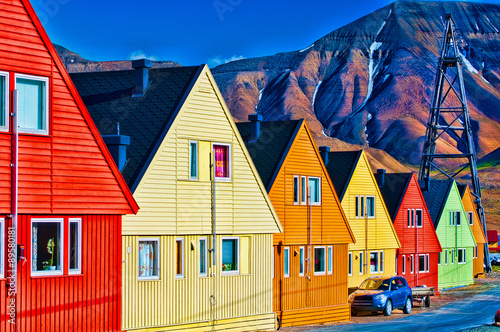 Fotografie, Obraz Digitally enhanced row of very colorful homes in Svalsbard, Norw