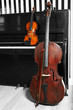 Cello and violin on piano background
