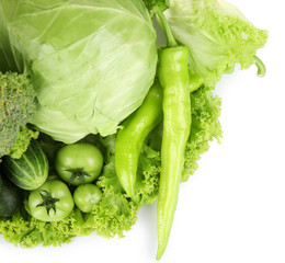 Fototapete - Heap of green vegetables isolated on white