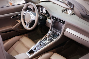 Dark luxury car Interior - steering wheel, shift lever and dashb