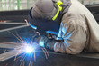 © ADS - welder is welding steel structure with safety mask and safety gloves in factory