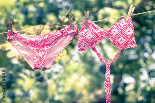 Fotografie, Obraz Retro tone image of cute bikini bathing suit hanging on a line to dry