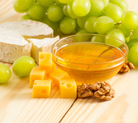 Wall Mural - Still life of cheese, honey, walnuts and grapes