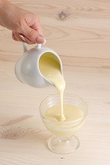 Pouring condensed milk in a bowl