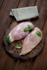 Wall Mural - Top view of raw chicken breast fillets, rustic wooden background