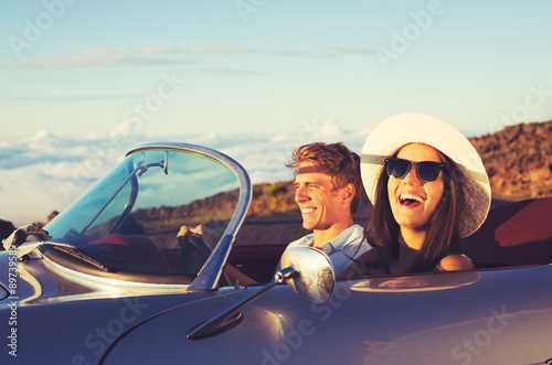 Obraz na plátne Young Couple in Classic Vintage Sports Car