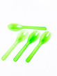 Green plastic spoon on white background