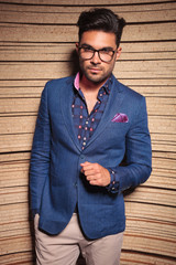 Poster - Young fashion man posing on wood background