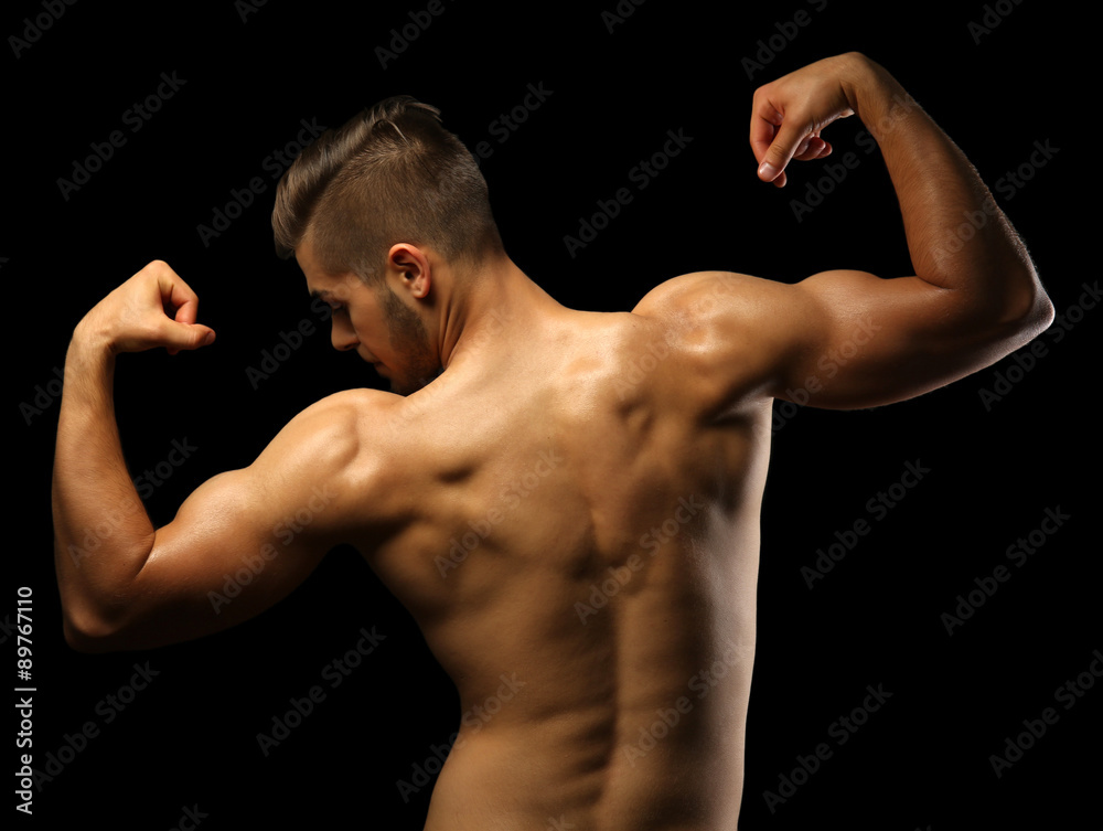 Muscle young man on dark background