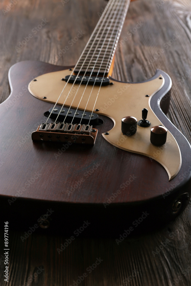 Electric guitar on wooden table close up