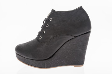 platform shoes made of black leather with laces on white background