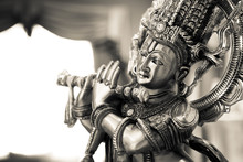 Black And White Statue Of The Hindu God Krishna Playing A Flute